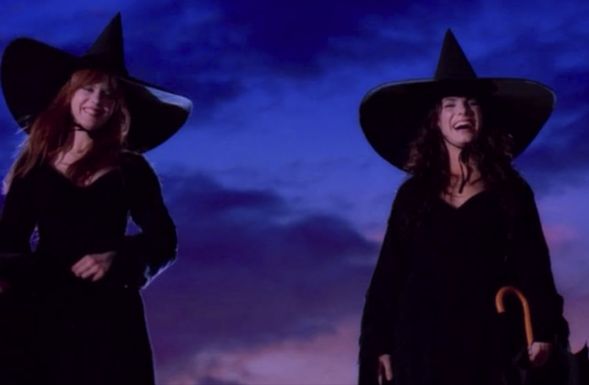 Gilly and Sally are overjoyed in tall witch hats on the roof of their home, the sun having just set behind them.